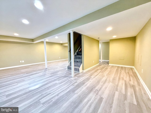 basement with light hardwood / wood-style flooring