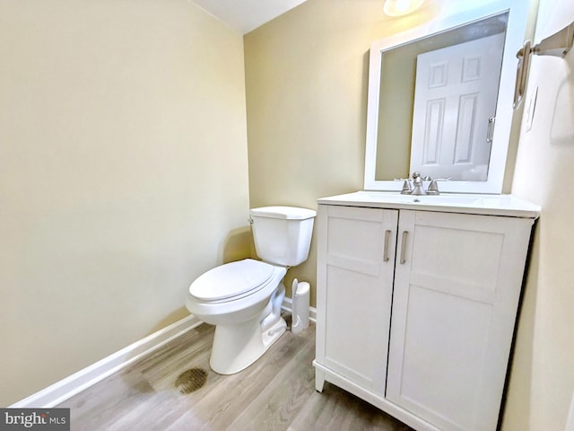 bathroom featuring vanity, toilet, and wood-type flooring