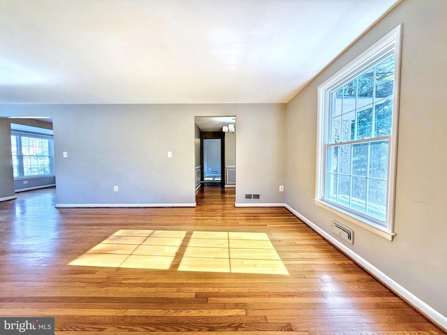 spare room with light hardwood / wood-style flooring