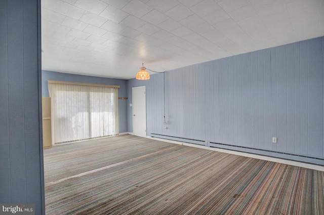 empty room featuring a baseboard radiator and carpet floors