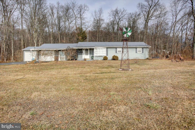 ranch-style house with a garage and a front lawn