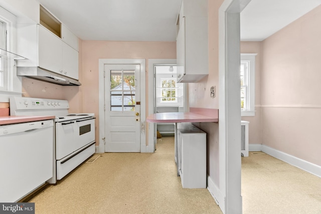 kitchen featuring white cabinetry and white appliances