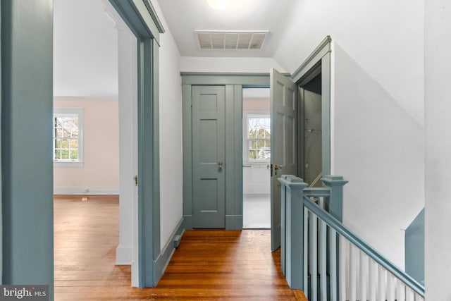 corridor featuring hardwood / wood-style floors and a wealth of natural light