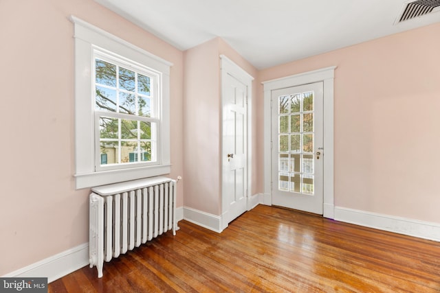 entryway featuring wood-type flooring and radiator