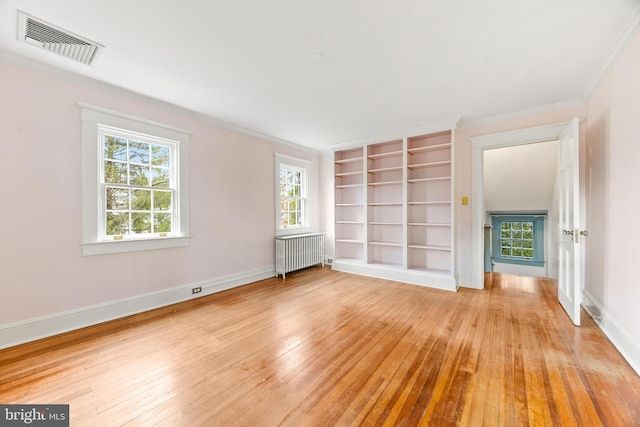 unfurnished living room with ornamental molding, radiator, and light hardwood / wood-style flooring