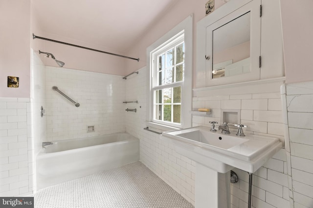 bathroom featuring tiled shower / bath combo, sink, tile walls, and tile patterned floors