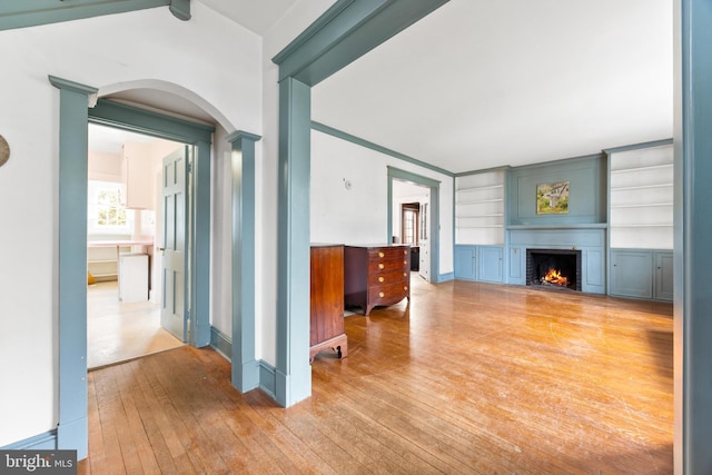 living room with hardwood / wood-style flooring and built in features