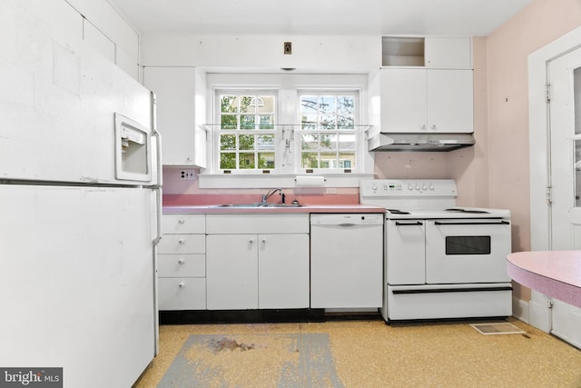 kitchen featuring sink, white cabinets, and white appliances