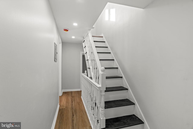 stairs featuring hardwood / wood-style floors