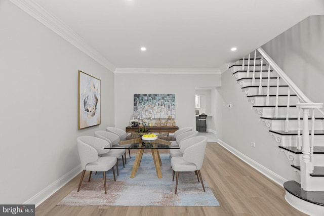 dining room with crown molding and hardwood / wood-style floors