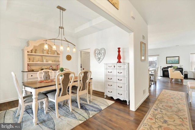 dining area with dark wood-type flooring