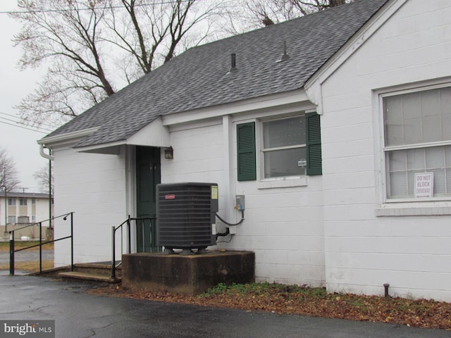 view of exterior entry featuring central AC unit