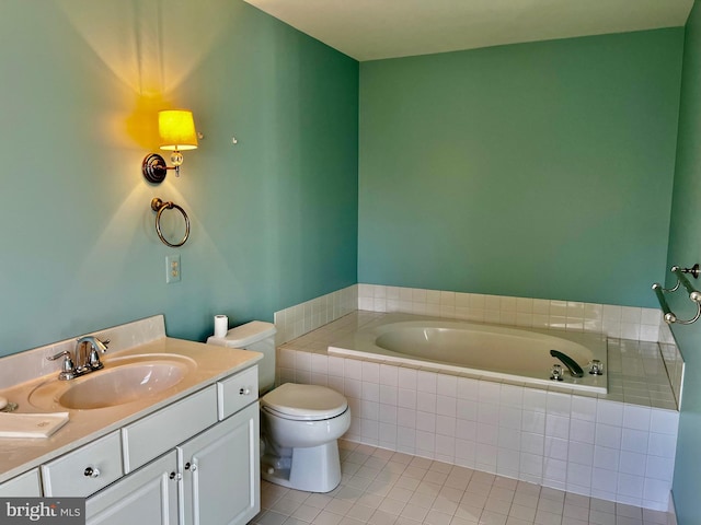 bathroom with tile patterned flooring, vanity, tiled bath, and toilet