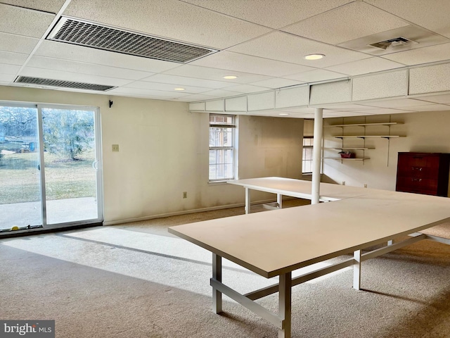 basement featuring carpet flooring and a drop ceiling