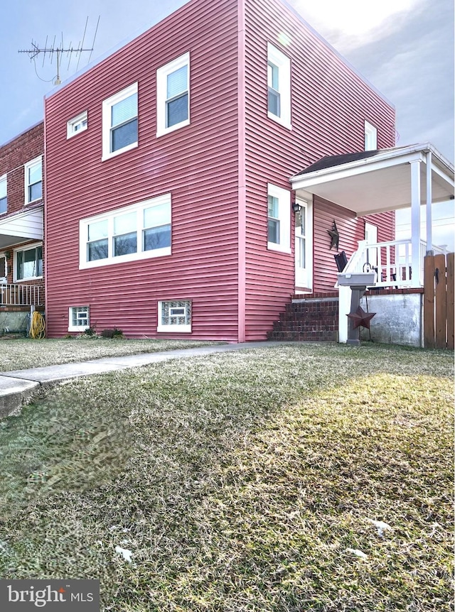 view of property exterior featuring a lawn