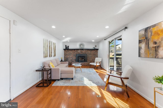 living room with recessed lighting, baseboards, and light wood finished floors