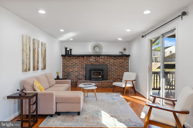 living room with recessed lighting, baseboards, and wood finished floors