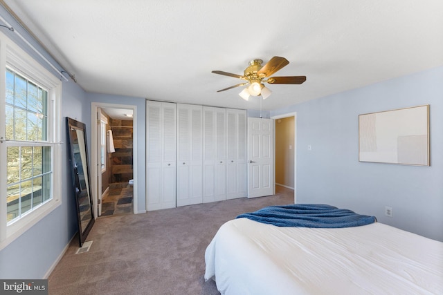 bedroom with visible vents, connected bathroom, carpet floors, a closet, and a ceiling fan