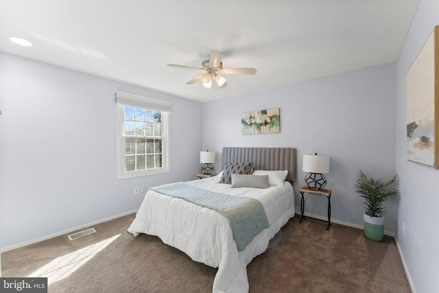 carpeted bedroom featuring a ceiling fan, baseboards, and visible vents