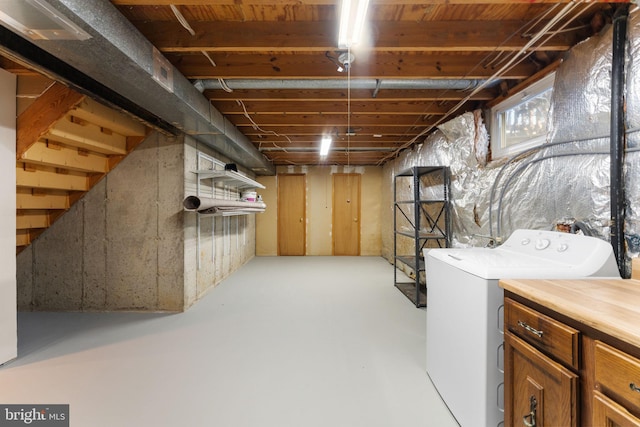 unfinished basement with washer / dryer