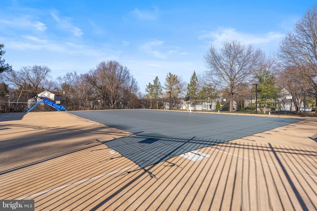 view of swimming pool featuring fence