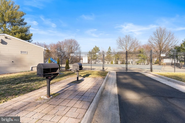 view of street featuring curbs and a gated entry