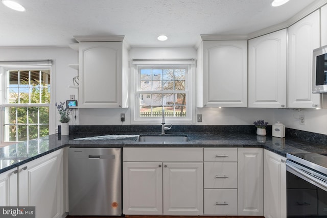 kitchen featuring a sink, white cabinetry, and stainless steel appliances