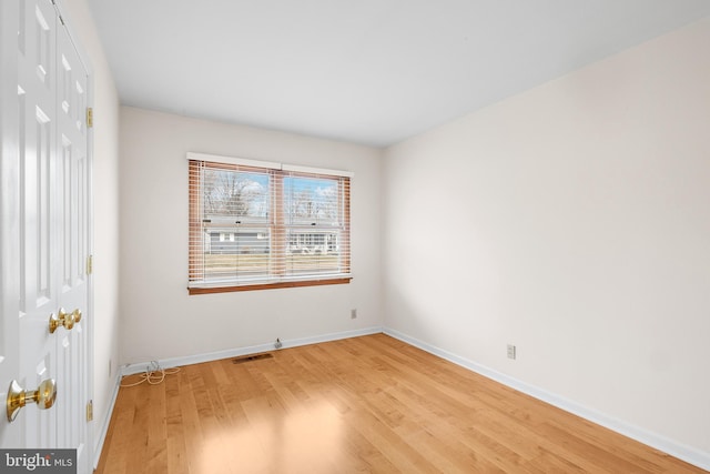 empty room with hardwood / wood-style floors