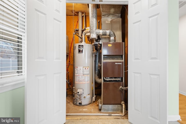 utility room featuring gas water heater