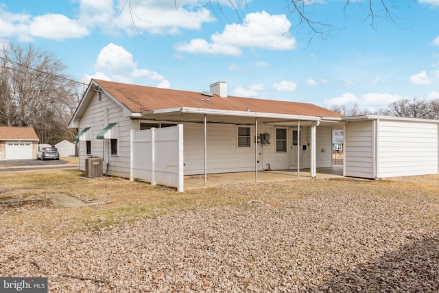 rear view of house with cooling unit and a patio