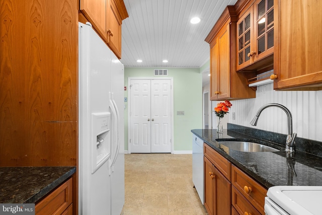 kitchen featuring light tile patterned flooring, sink, dark stone counters, wood ceiling, and white appliances