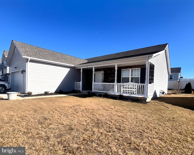 ranch-style home featuring a garage and covered porch