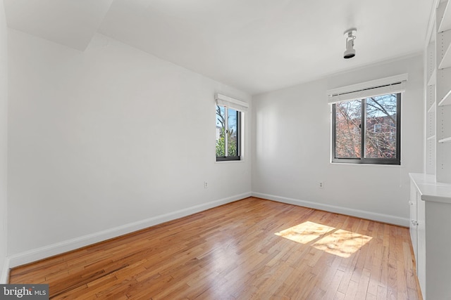 spare room featuring light wood-type flooring