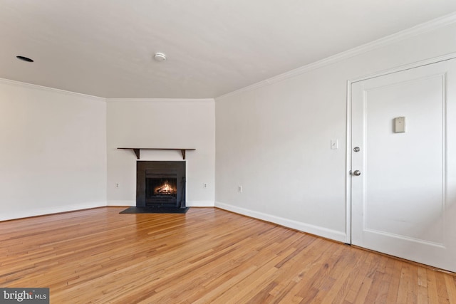 unfurnished living room featuring crown molding and light hardwood / wood-style flooring