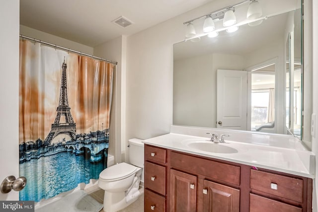 full bathroom featuring vanity, shower / bath combo, and toilet