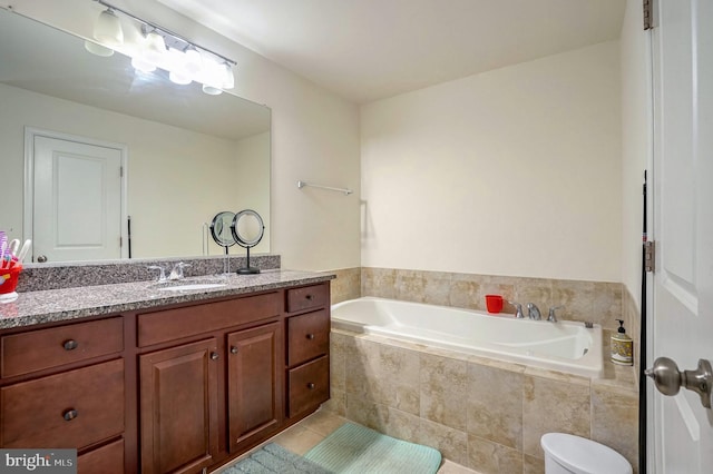 bathroom with a relaxing tiled tub, tile patterned floors, and vanity