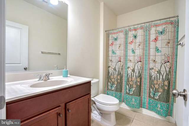 bathroom featuring vanity, tile patterned floors, toilet, and walk in shower