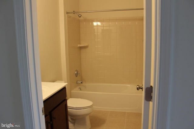 full bathroom featuring tile patterned flooring, vanity, tiled shower / bath combo, and toilet