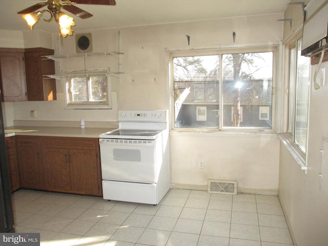 kitchen featuring ceiling fan, white range with electric cooktop, and light tile patterned floors