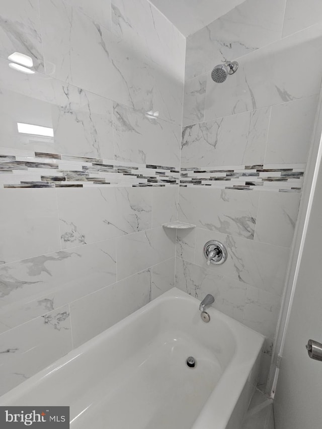 bathroom featuring tiled shower / bath