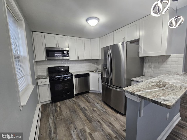 kitchen with sink, white cabinetry, hanging light fixtures, stainless steel appliances, and a baseboard radiator