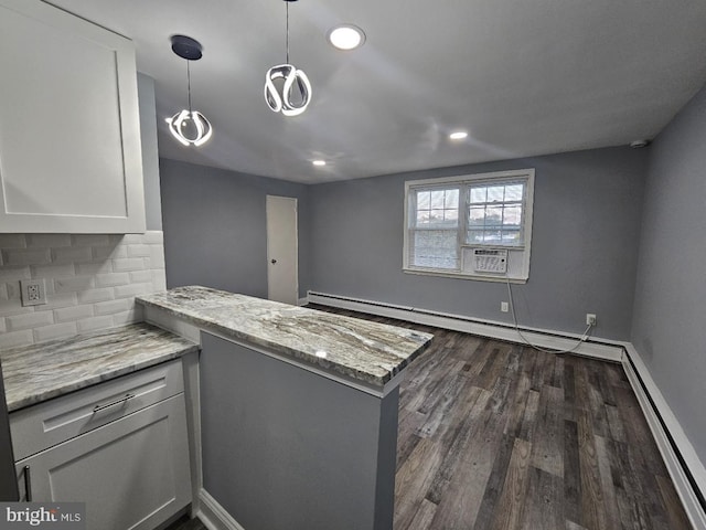 kitchen featuring white cabinetry, hanging light fixtures, baseboard heating, kitchen peninsula, and light stone countertops