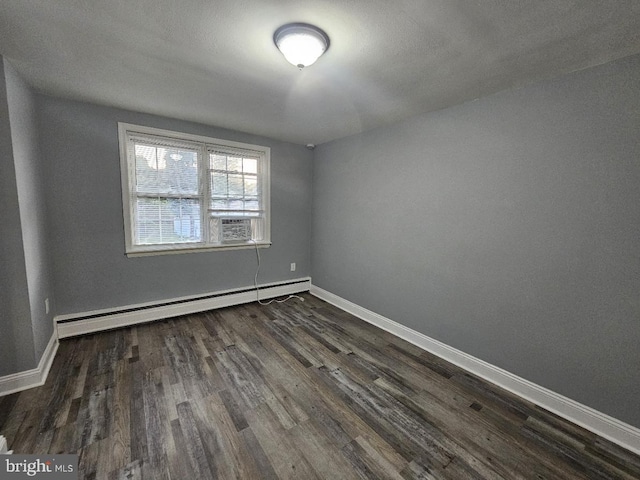 empty room with dark hardwood / wood-style flooring, cooling unit, and baseboard heating