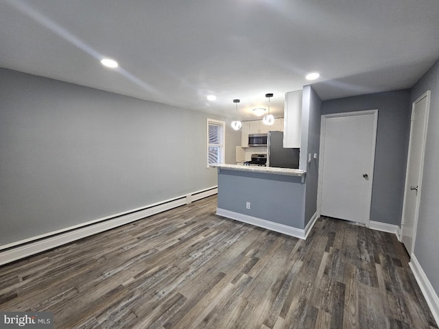 kitchen with white cabinetry, a baseboard heating unit, stainless steel appliances, dark hardwood / wood-style floors, and kitchen peninsula