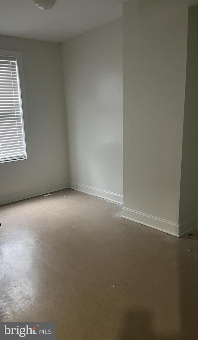 spare room with concrete floors