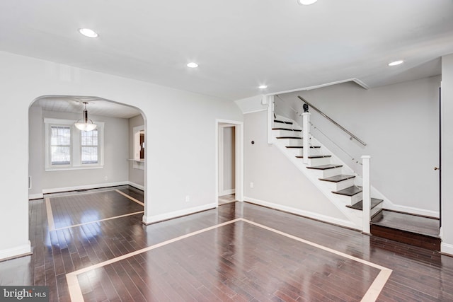 127 Cherrydell, Catonsville, MD 21228 - unfurnished living room featuring dark wood-style floors, arched walkways, baseboards, and recessed lighting
