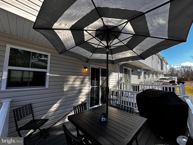 wooden deck featuring area for grilling