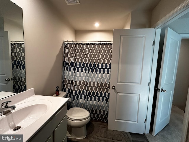 bathroom with vanity, toilet, and a shower with curtain