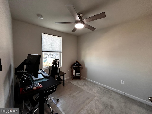 carpeted office featuring ceiling fan