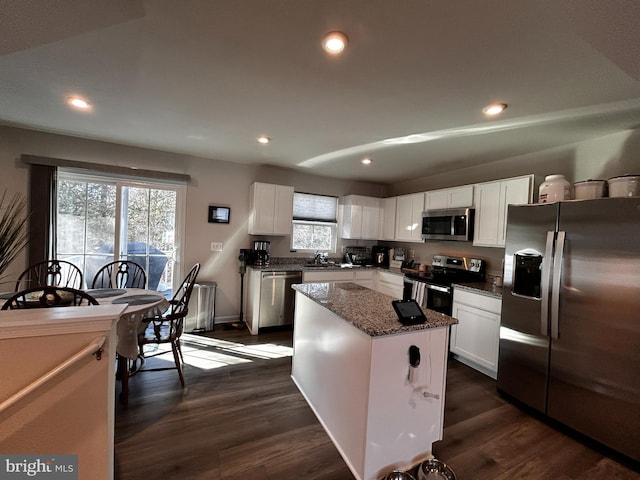 kitchen with a kitchen island, white cabinetry, and appliances with stainless steel finishes